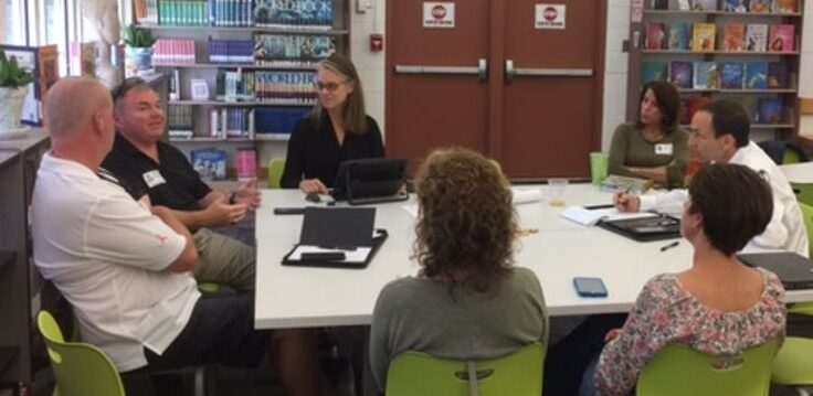 People collaborating in a library room